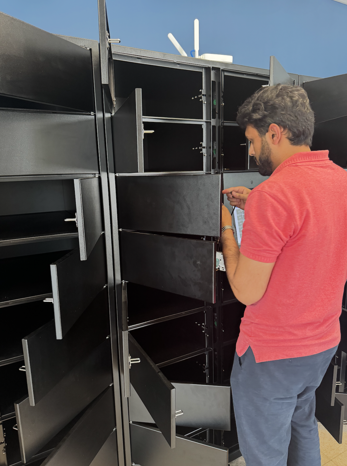 Accessa technician wiring locker doors during an install