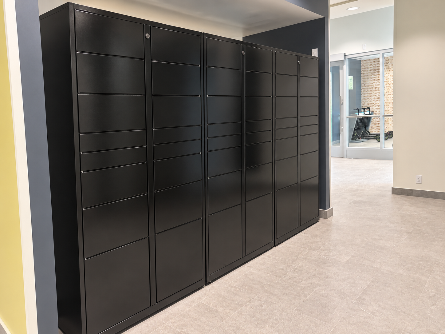 Row of black Accessa Parcel lockers installed in a residential amenity corridor